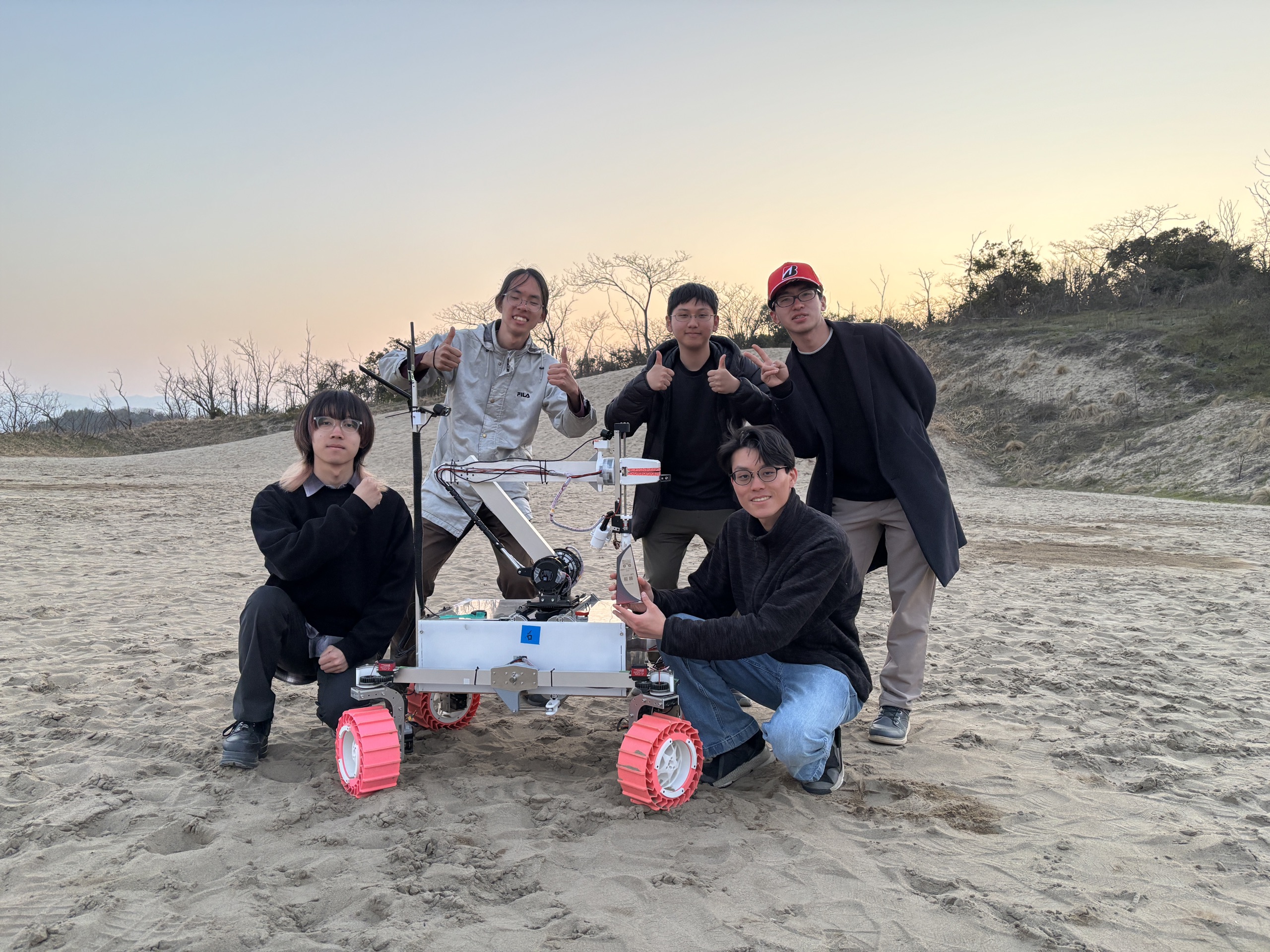 TSUKUBA ROVER TEAM members with TSUKUBA ROVER 1 on the Tottori sand dunes